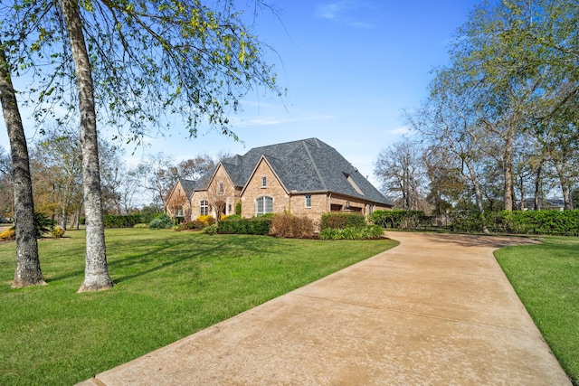 view of side of home with a lawn