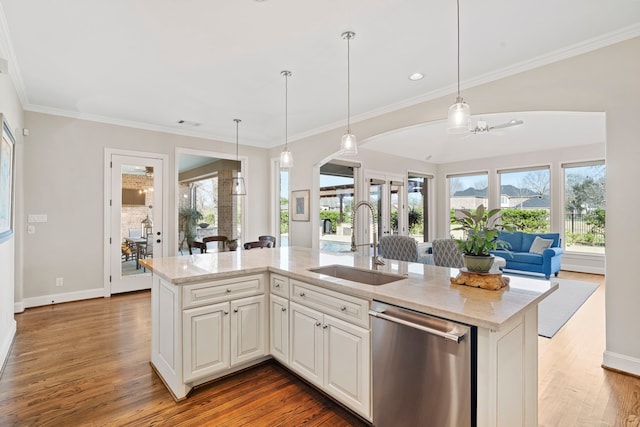 kitchen featuring ceiling fan, dishwasher, sink, an island with sink, and white cabinets