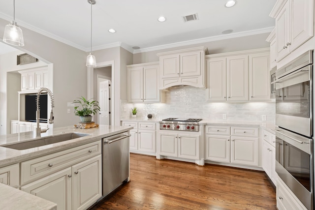 kitchen with white cabinets, decorative backsplash, sink, and stainless steel appliances