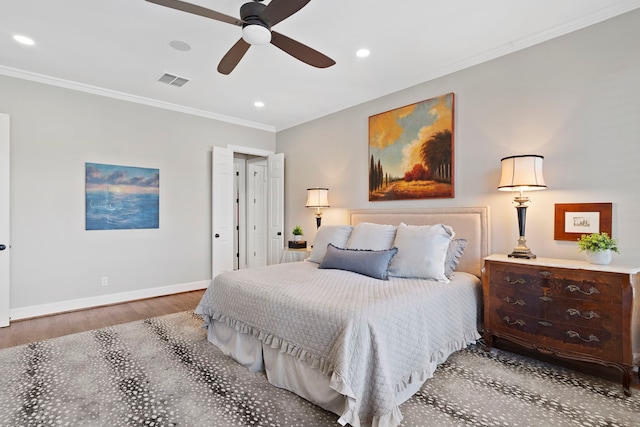 bedroom with ceiling fan, ornamental molding, and wood-type flooring