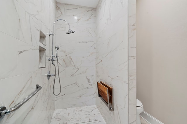 bathroom with toilet and a tile shower