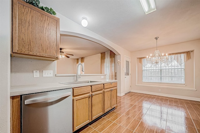 kitchen featuring ceiling fan with notable chandelier, decorative light fixtures, stainless steel dishwasher, and sink