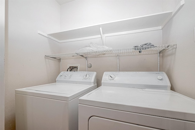 clothes washing area with washer and clothes dryer