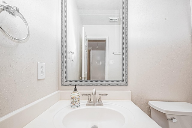 bathroom with toilet and vanity