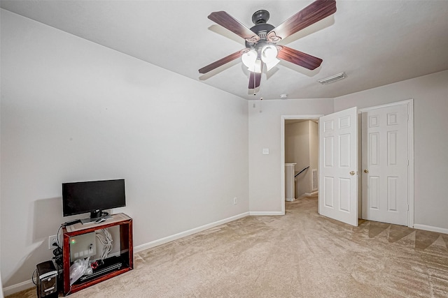 unfurnished bedroom featuring ceiling fan and light carpet