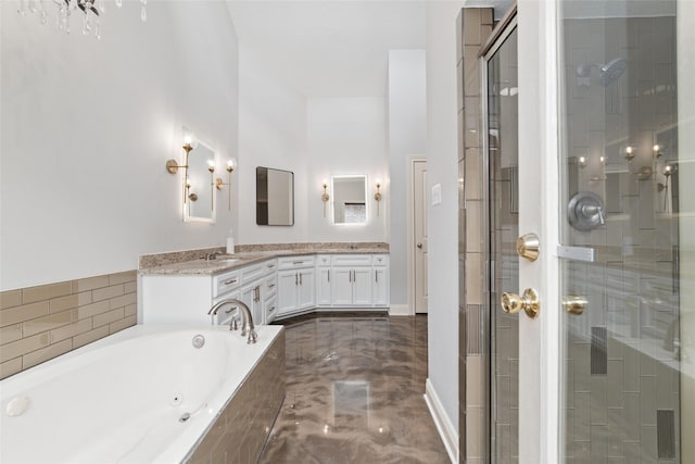 bathroom with vanity and shower with separate bathtub