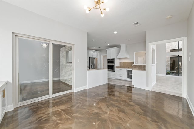 unfurnished living room featuring a chandelier