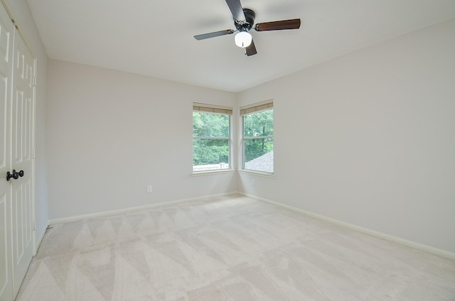 empty room featuring light carpet and ceiling fan