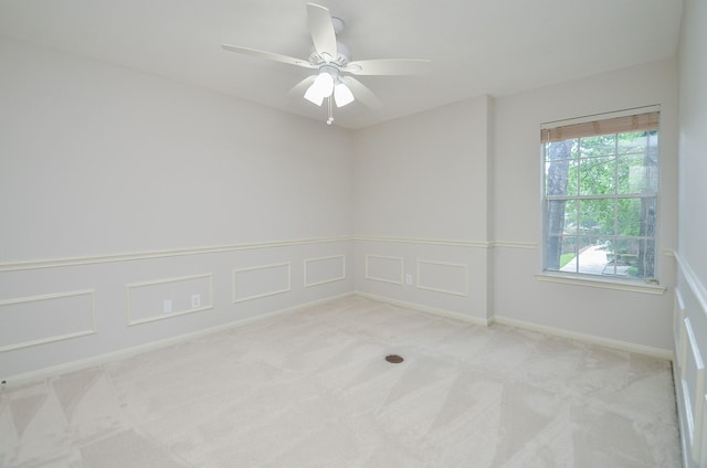 carpeted spare room with ceiling fan