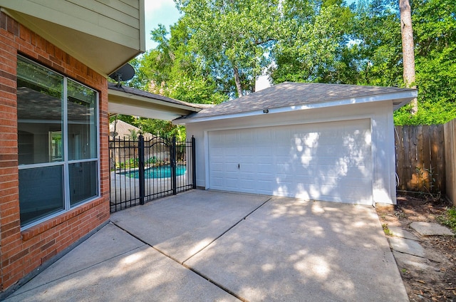 garage featuring a fenced in pool