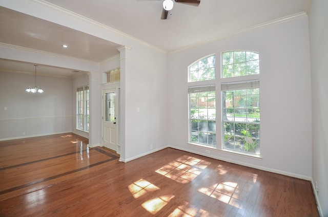 unfurnished room with wood-type flooring, ceiling fan with notable chandelier, and crown molding