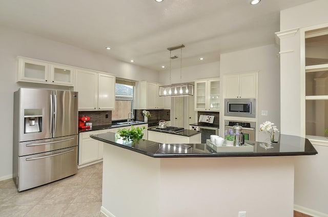 kitchen with light tile patterned floors, stainless steel appliances, pendant lighting, white cabinets, and sink