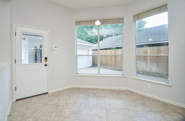 interior space with light tile patterned floors and a healthy amount of sunlight