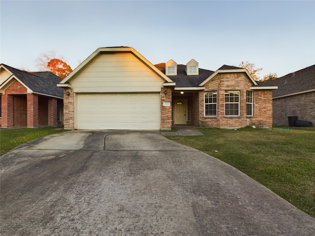 view of front of property featuring a front yard and a garage