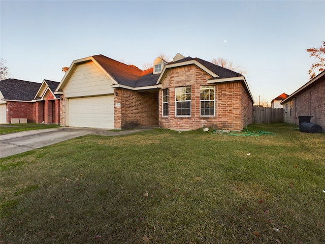 ranch-style house with a garage and a yard