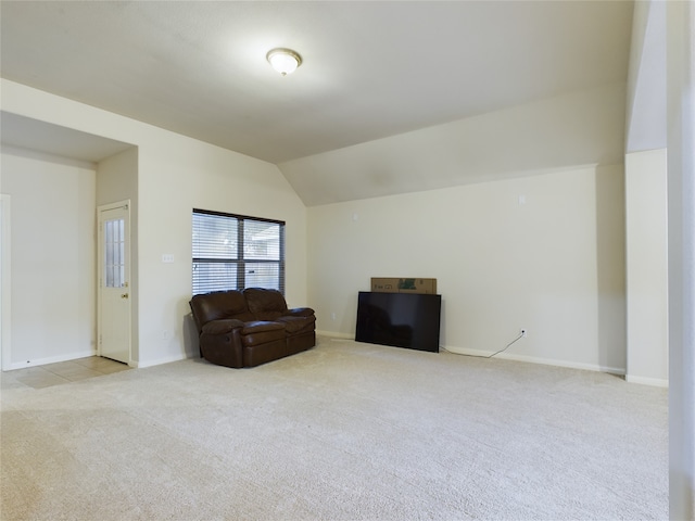 sitting room with lofted ceiling and light colored carpet