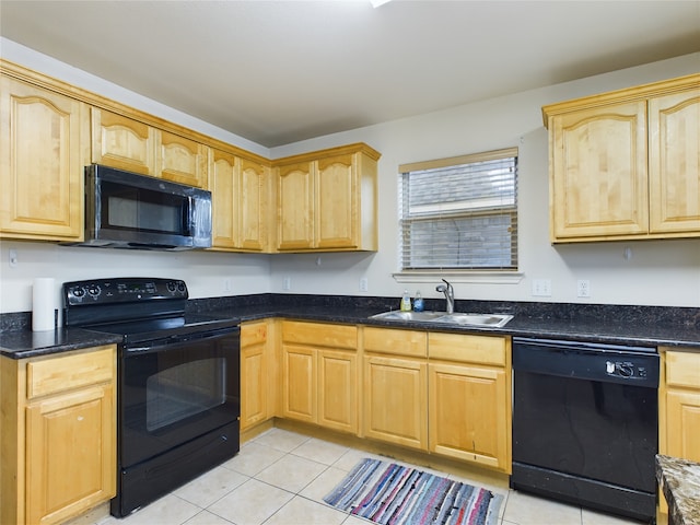 kitchen with black appliances, light brown cabinets, dark stone countertops, sink, and light tile patterned floors