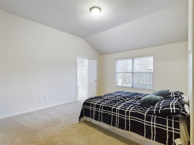 bedroom with vaulted ceiling and carpet flooring