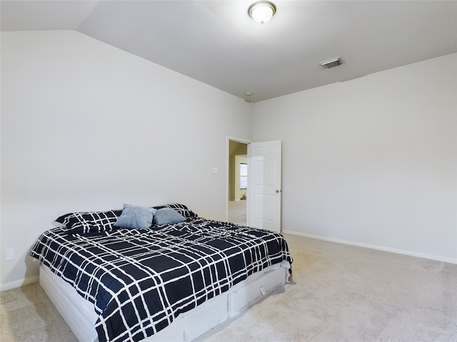 bedroom with carpet floors and lofted ceiling