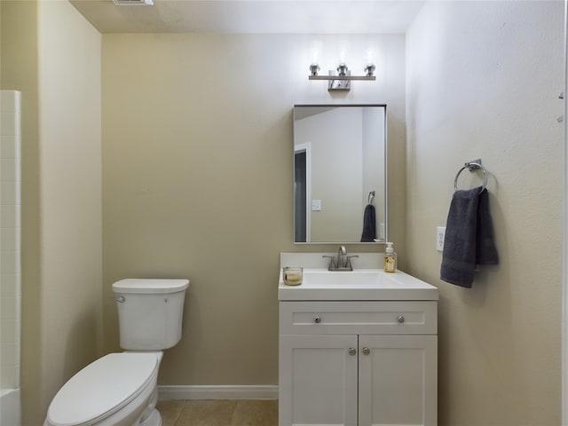 bathroom with toilet, vanity, and tile patterned flooring