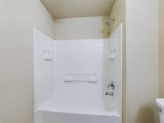 bathroom with shower / bathing tub combination and toilet