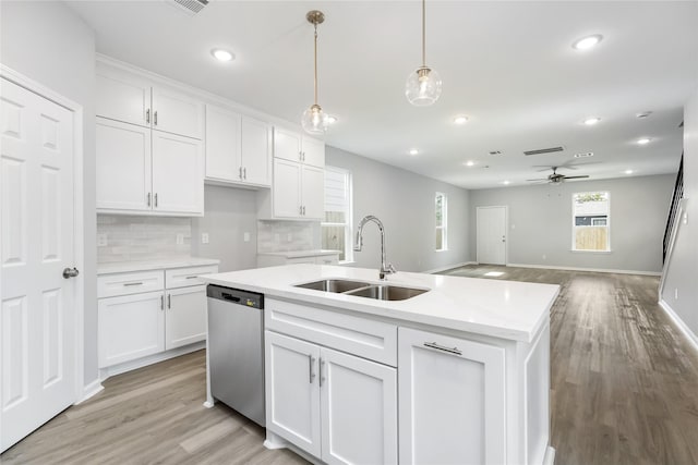 kitchen featuring ceiling fan, white cabinetry, stainless steel dishwasher, and sink