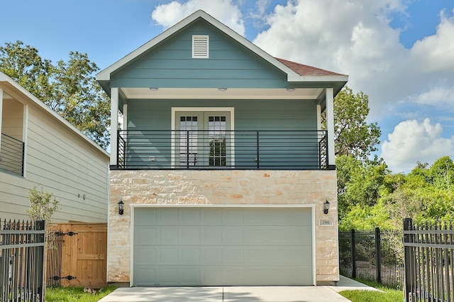 view of front facade with a balcony and a garage