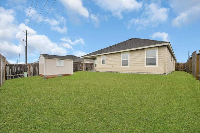 rear view of property featuring a yard and a storage shed