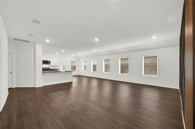 unfurnished living room featuring dark hardwood / wood-style floors