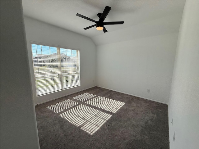 carpeted empty room featuring ceiling fan and vaulted ceiling