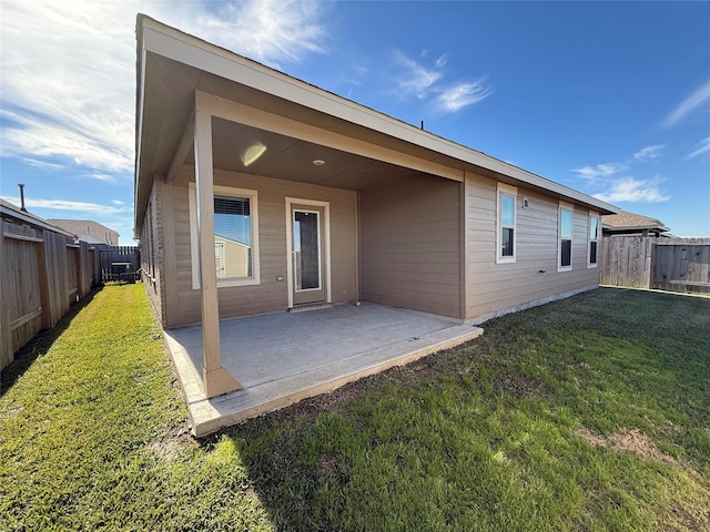 back of property featuring a yard and a patio