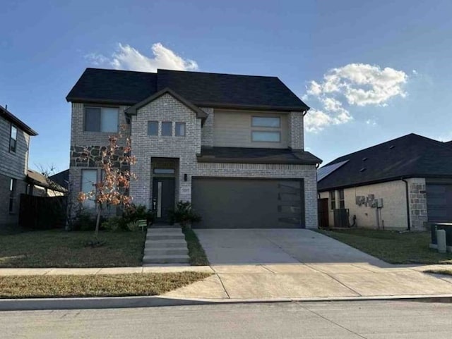 view of front of property with central AC and a garage