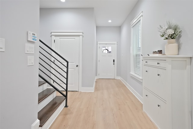 foyer entrance with light hardwood / wood-style floors