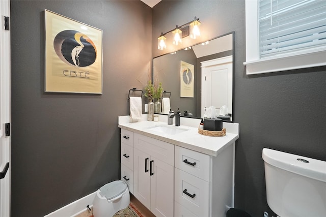 bathroom featuring toilet and vanity