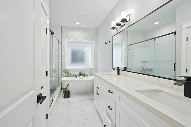 bathroom featuring vanity and shower with separate bathtub