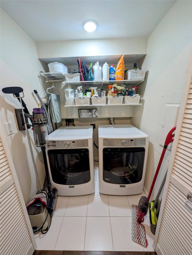 laundry room with light tile patterned floors and separate washer and dryer