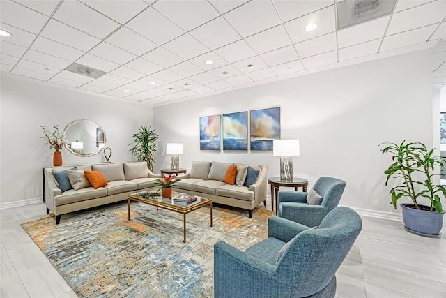 living room featuring a paneled ceiling