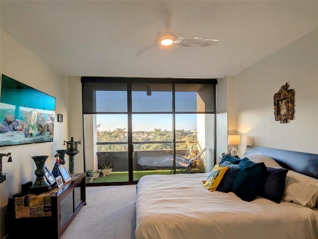 carpeted bedroom with expansive windows, access to outside, and ceiling fan