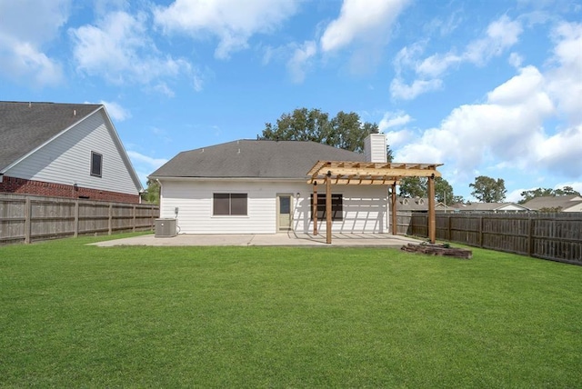 rear view of property featuring a pergola, a patio area, central air condition unit, and a yard