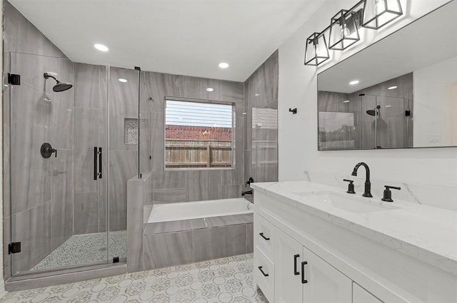 bathroom with tile patterned flooring, separate shower and tub, and vanity