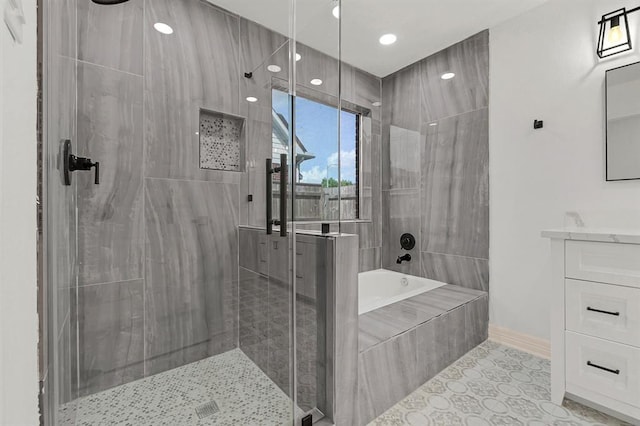 bathroom with vanity, tile patterned floors, and plus walk in shower