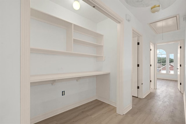 hallway with light hardwood / wood-style floors