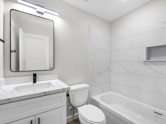 full bathroom with toilet, vanity, and tiled shower / bath combo