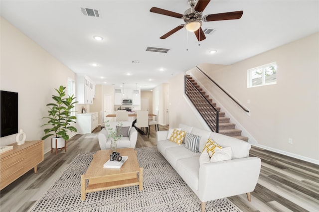 living room featuring hardwood / wood-style flooring and ceiling fan