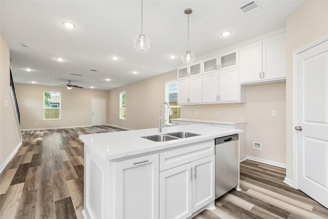 kitchen featuring white cabinetry, an island with sink, ceiling fan, stainless steel dishwasher, and sink