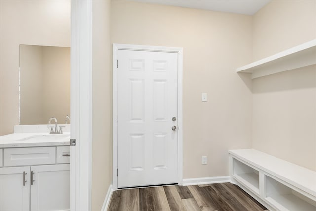 mudroom with dark hardwood / wood-style floors and sink