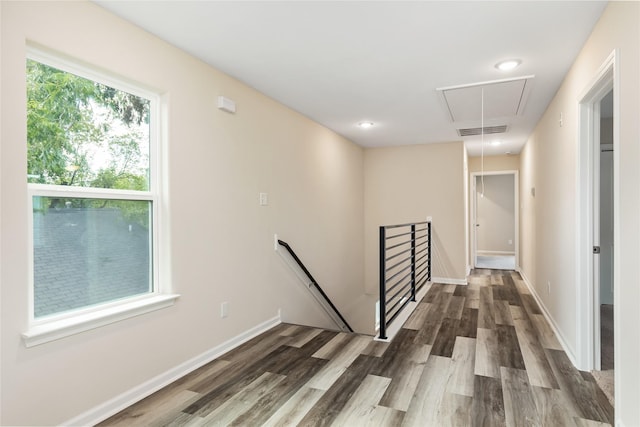 hallway with hardwood / wood-style floors