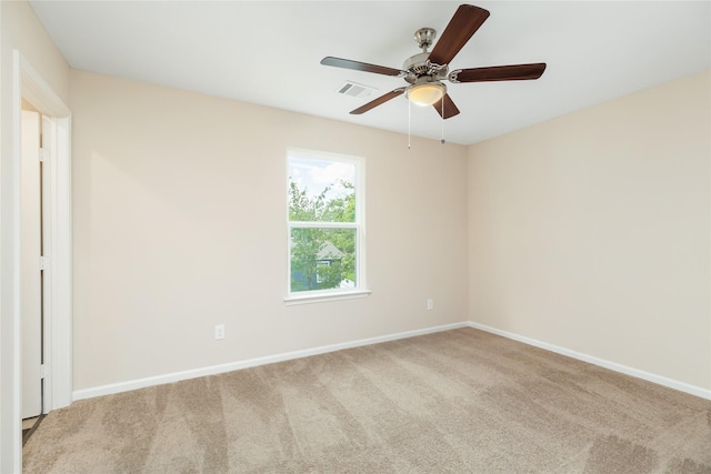 carpeted spare room featuring ceiling fan