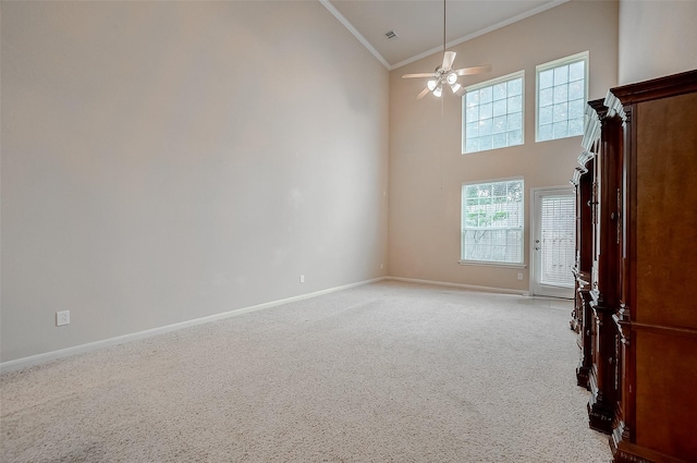 spare room with high vaulted ceiling, light carpet, crown molding, and ceiling fan