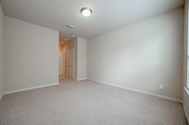 unfurnished room featuring light colored carpet